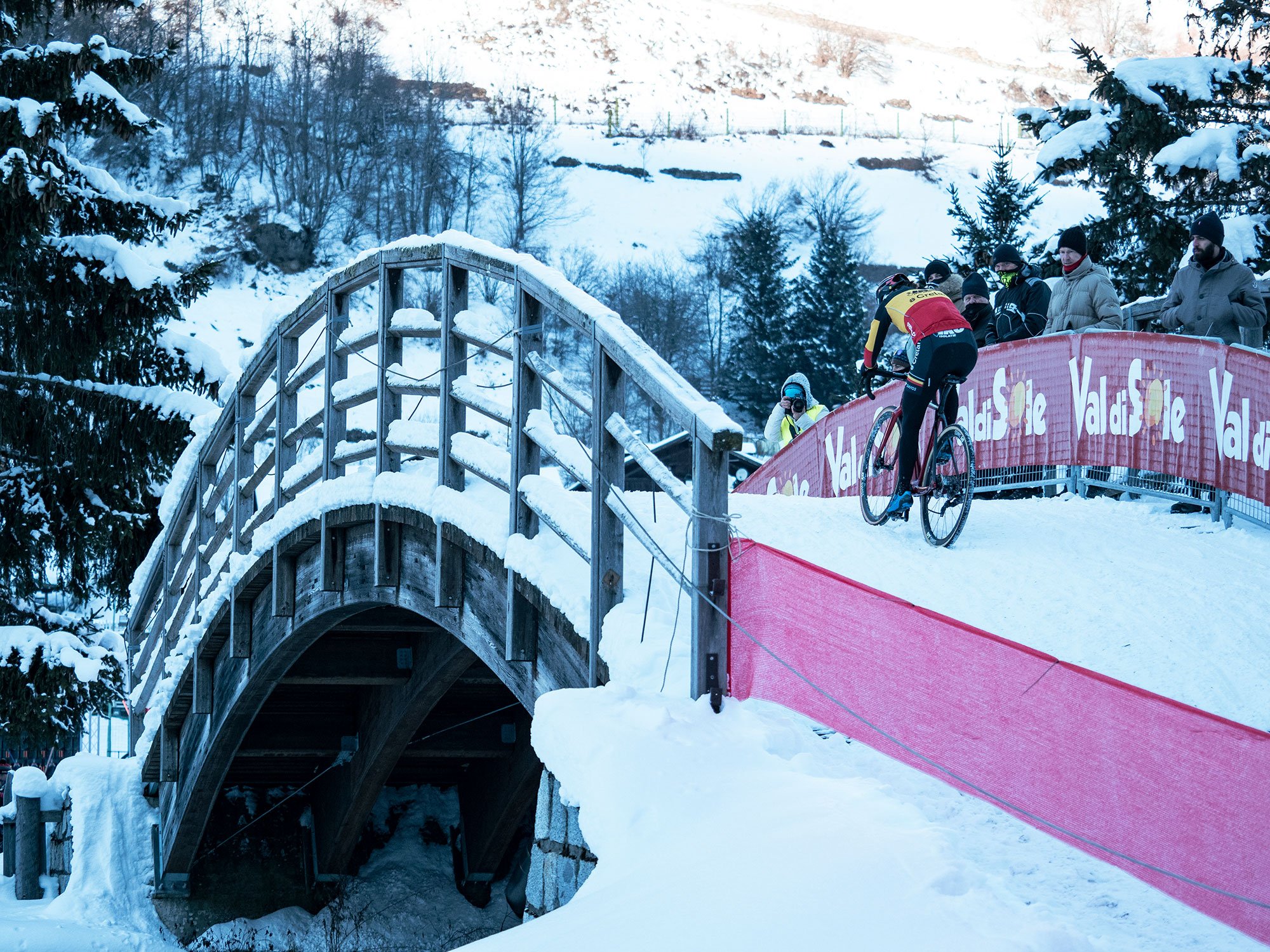 Sanne Cant rides over a snow covered bridge in Val di Sole